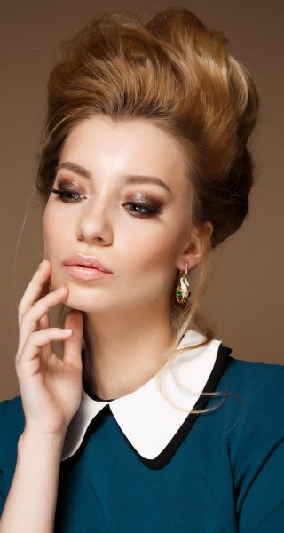 ThinkstockPhotos-518650320 Beautiful woman face close up studio with hight hairstyle
